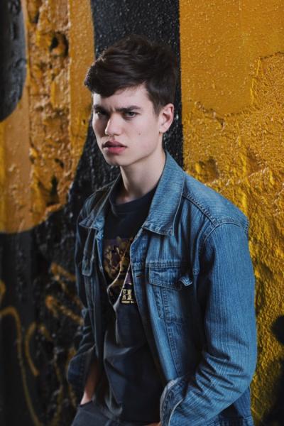 Boy standing in front of wall