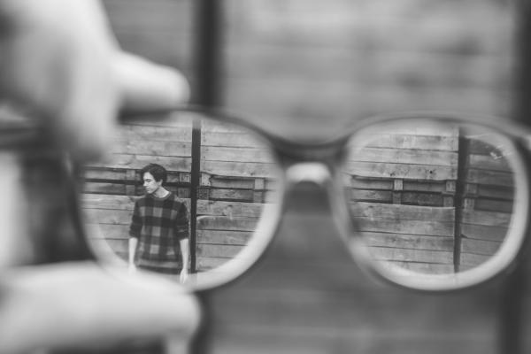 Man seen through glasses